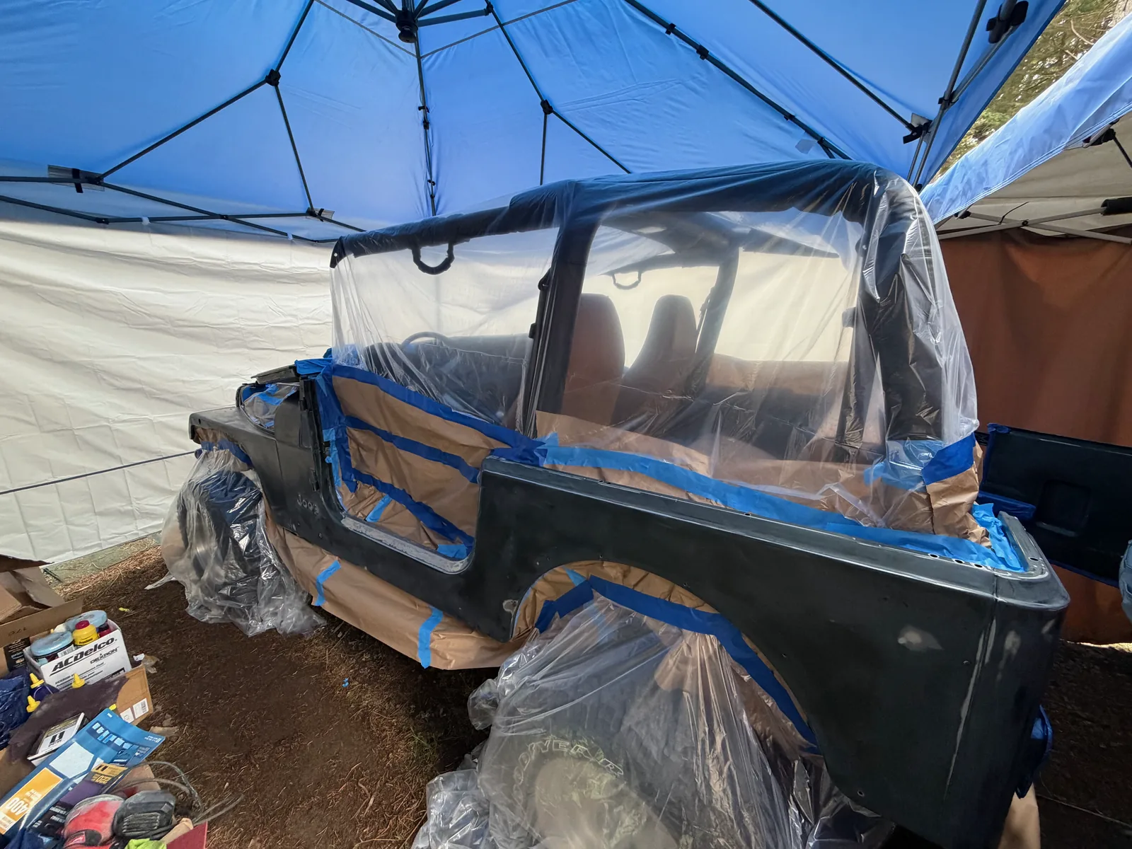 The Jeep wrapped in masking paper and plastic ready for primer