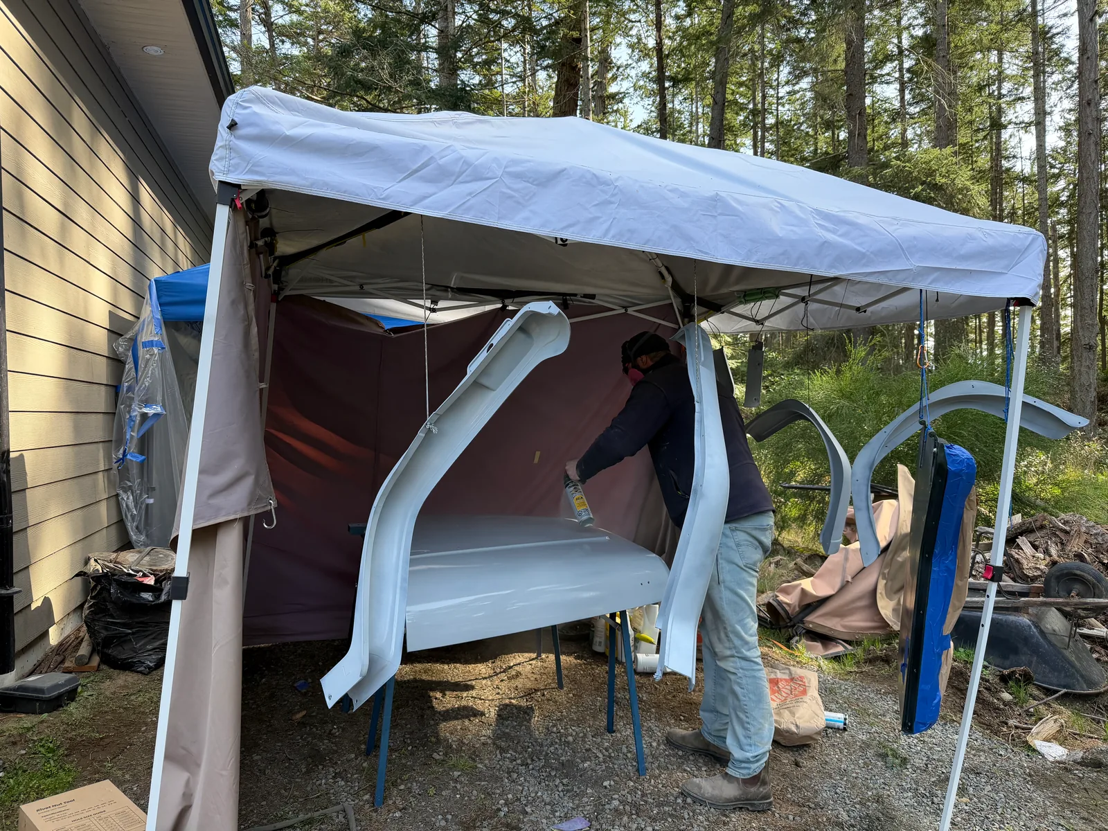 Working on the Jeep under the canopy against the house after dark
