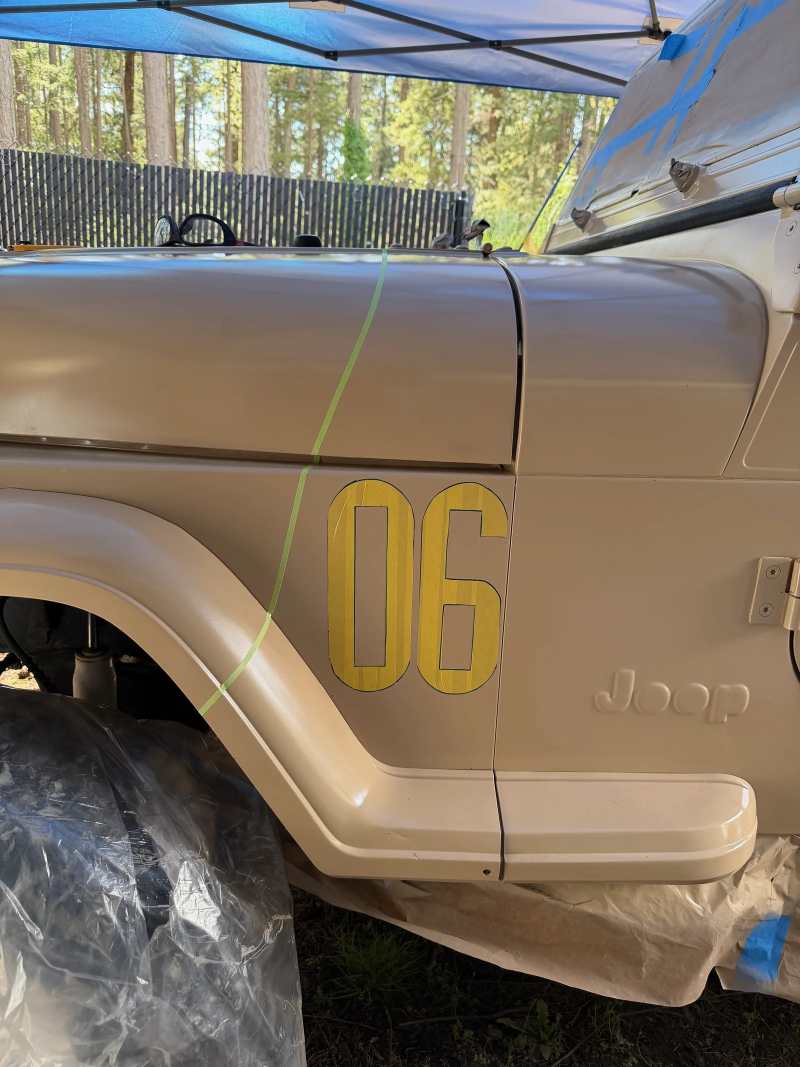 The yellow '06' number taking shape on the rear quarter panel