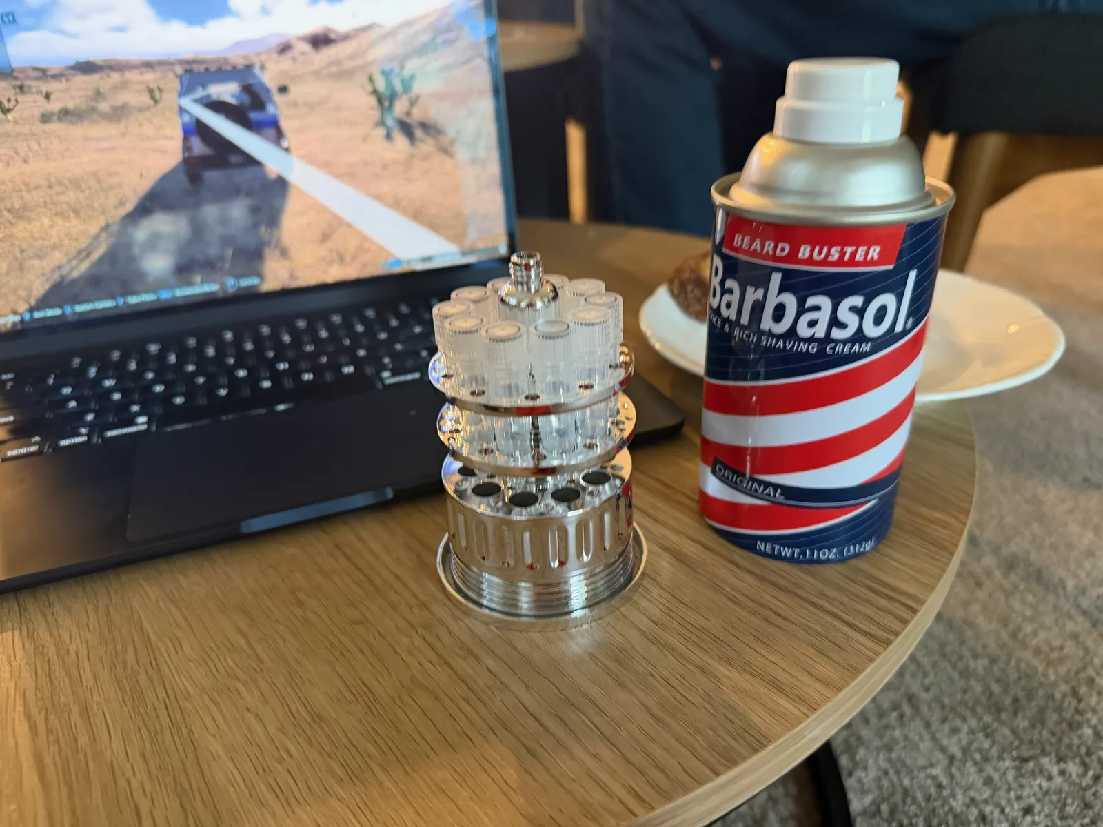 A replica Barbasol shaving cream can — the Jurassic Park embryo smuggling prop — on a table with dinosaur toys