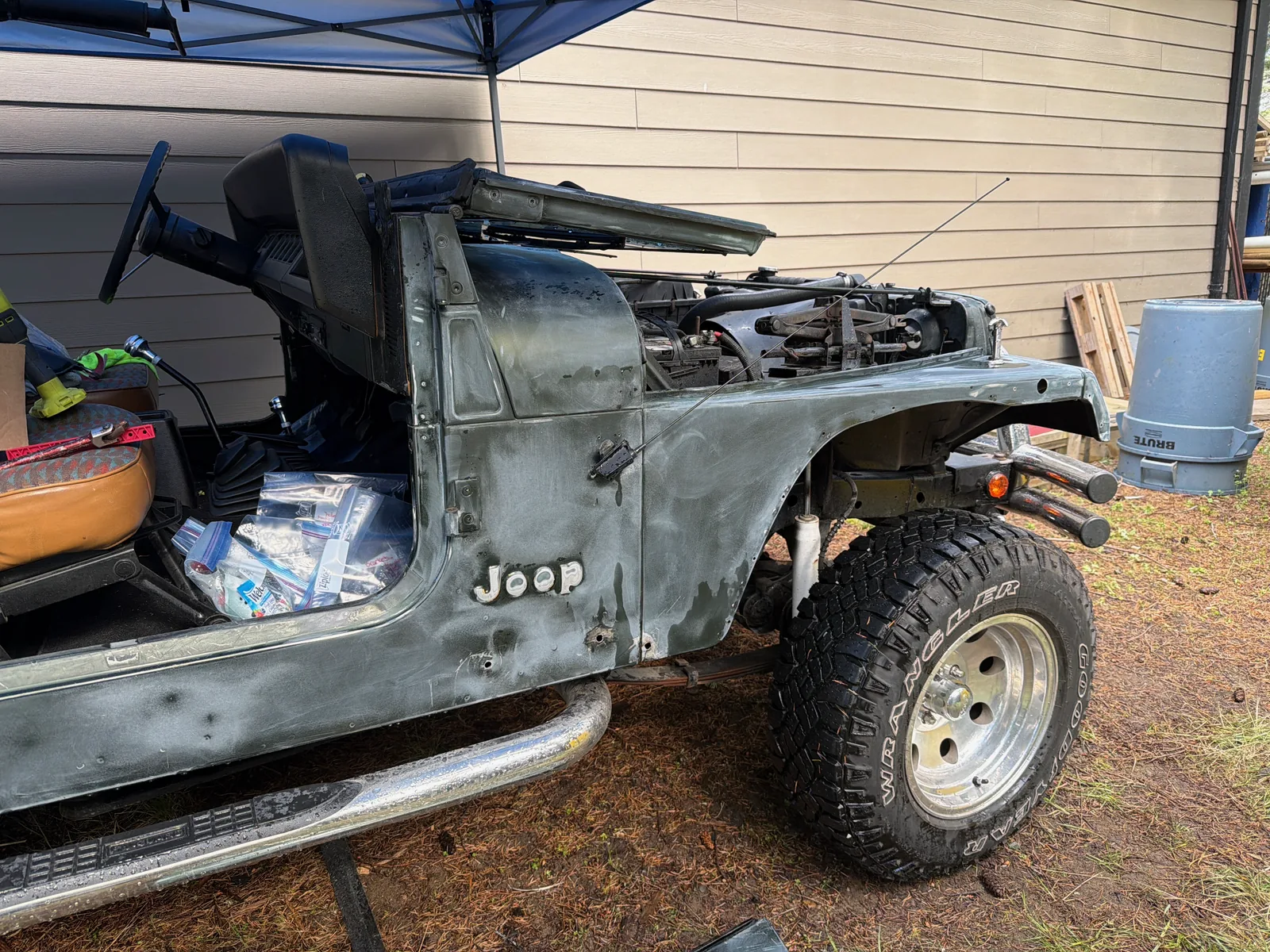 The Jeep stripped down to bare body with panels and trim removed