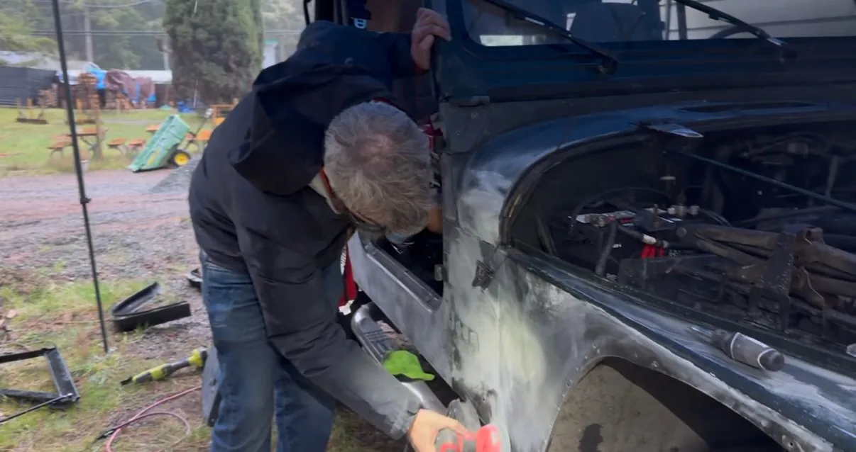 Sanding down the Jeep body panels outdoors