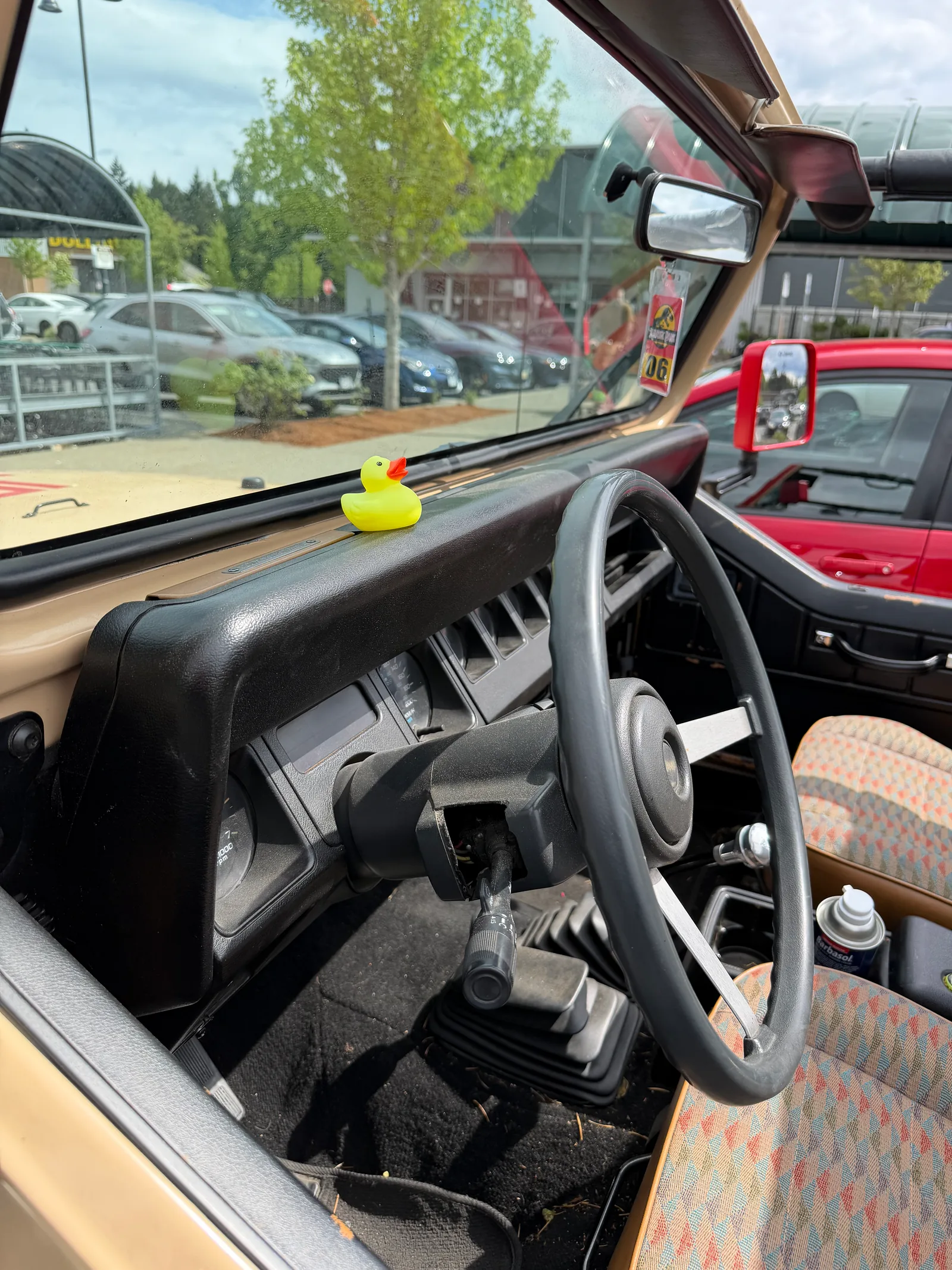 The Jeep interior — steering wheel and dash with a small rubber duck